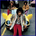 Picture of Jimi Hendrix on the hood of a Lotus Elan.